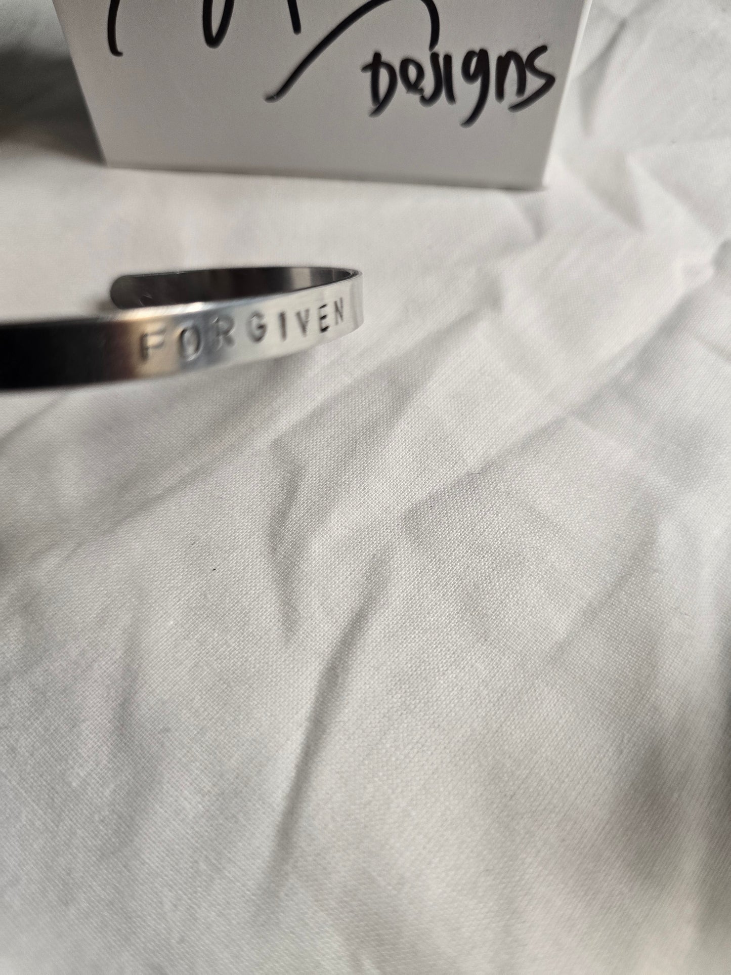 Forgiven metal bracelet